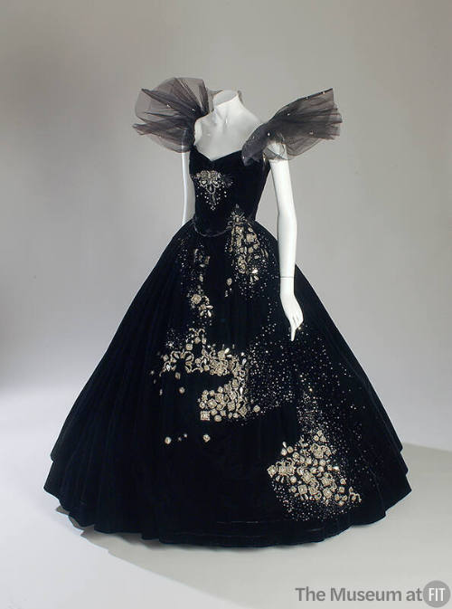 Black strapless two-piece dress with wide floor length flared skirt and oversize tulle ruffles …