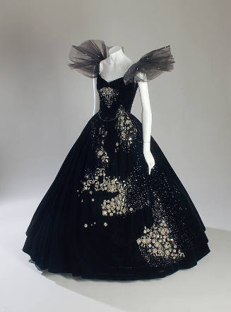 Black strapless two-piece dress with wide floor length flared skirt and oversize tulle ruffles …
