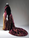 Side view of purple dress showing elbow length puff sleeves, yellow underskirt and long train w…