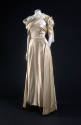 Ivory two-piece dress with strapless bodice, floor length skirt and stole draped asymmetrically…