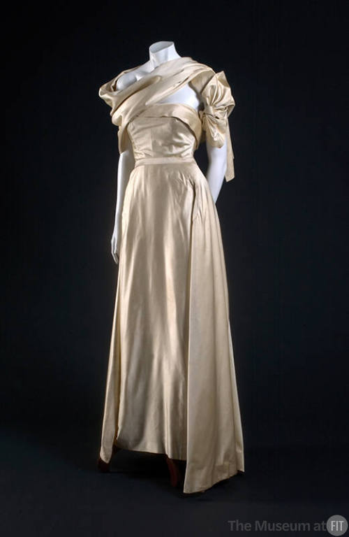 Ivory two-piece dress with strapless bodice, floor length skirt and stole draped asymmetrically…