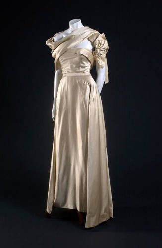 Ivory two-piece dress with strapless bodice, floor length skirt and stole draped asymmetrically…