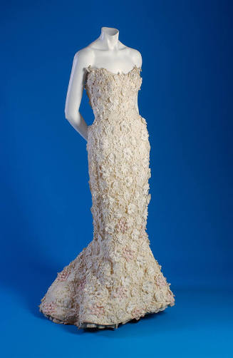 White strapless floor length dress with all over embroidered floral applique and fishtail skirt…