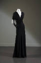 Sheer black floor-length evening dress with v-neck and pleating across midriff