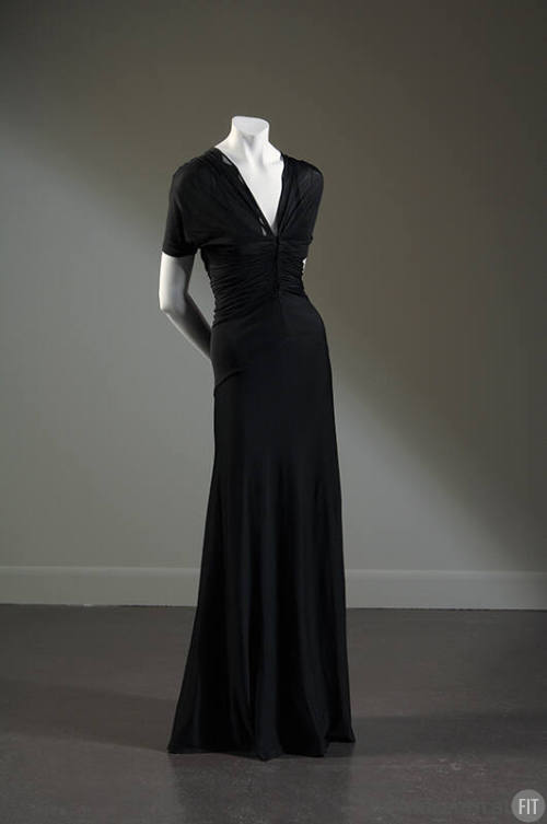 Sheer black floor-length evening dress with v-neck and pleating across midriff