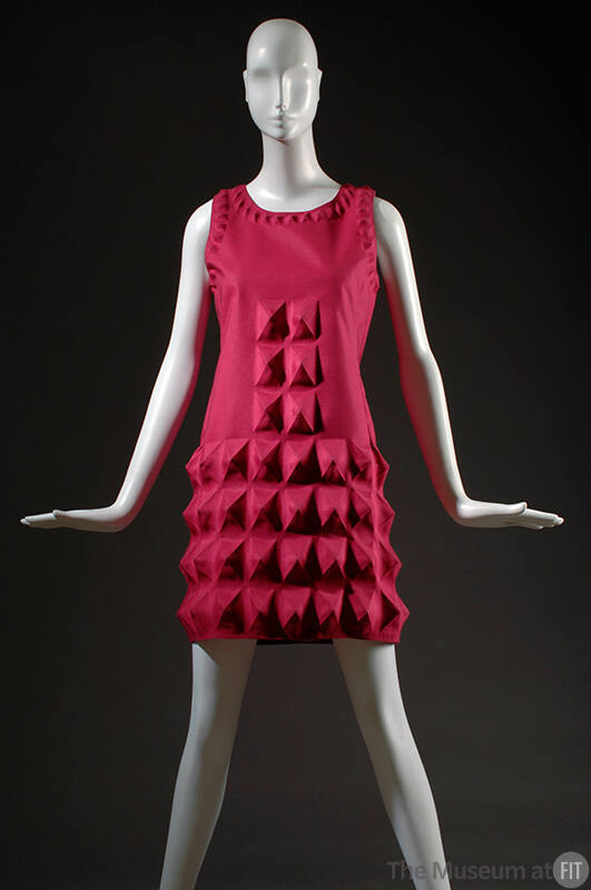 Fuchsia pink sleeveless mini dress with small molded diamond pattern around neck and arm holes …