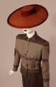 Brown and ivory jacket with shirt collar styled with a brown straight skirt and teracotta color…