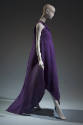 Side view of loose purple floor-length sleeveless dress with crossed halter neckline