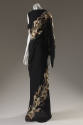 Full length black sleeveless evening dress with beige lily print spiralin from hem to left shou…
