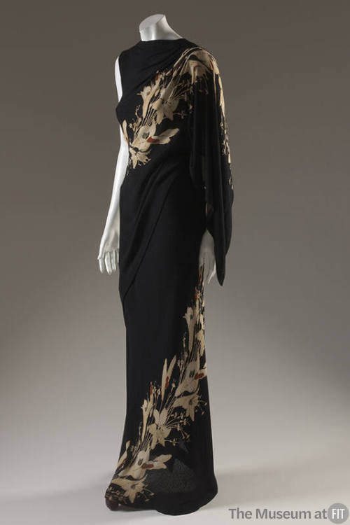 Full length black sleeveless evening dress with beige lily print spiralin from hem to left shou…