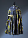Cape coat of yellow and grey plaid with crossed and buttoned band collar and narrow sleeves