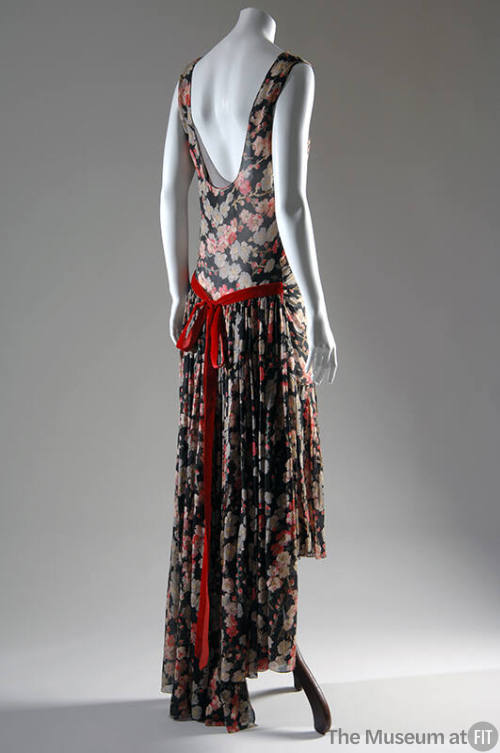 Back view of a sleeveless evening dress with low-cut back printed in pink and grey floral patte…