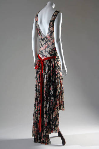 Back view of a sleeveless evening dress with low-cut back printed in pink and grey floral patte…