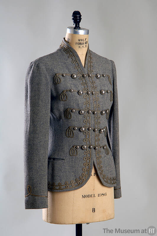 Grey fitted jacket with graduated frogs linking multiple round silver metal buttons