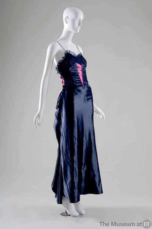 Navy blue floor-length evening dress with spaghetti straps, ruffled bodice, and boned corselet …