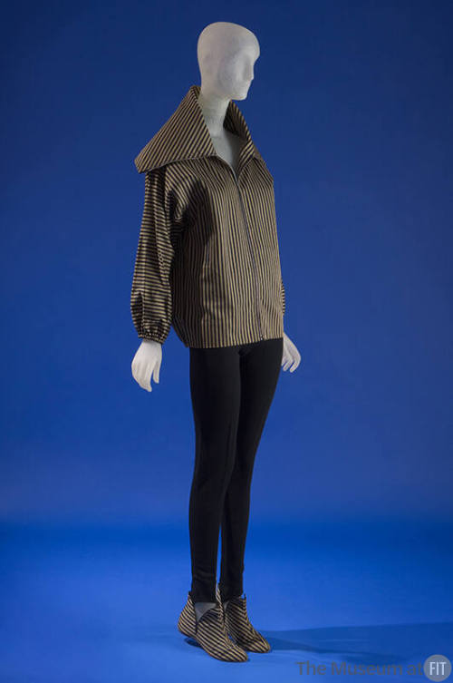 Ensemble of striped zippered jacket with exta-broad collar styled with black wool jersey tapere…