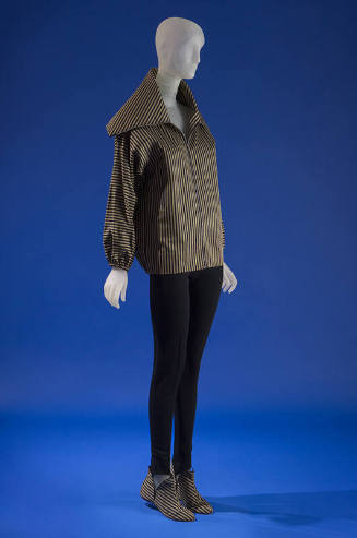 Ensemble of striped zippered jacket with exta-broad collar styled with black wool jersey tapere…