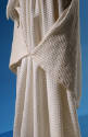 close up of long full skirt with square side extensions forming back bustle
