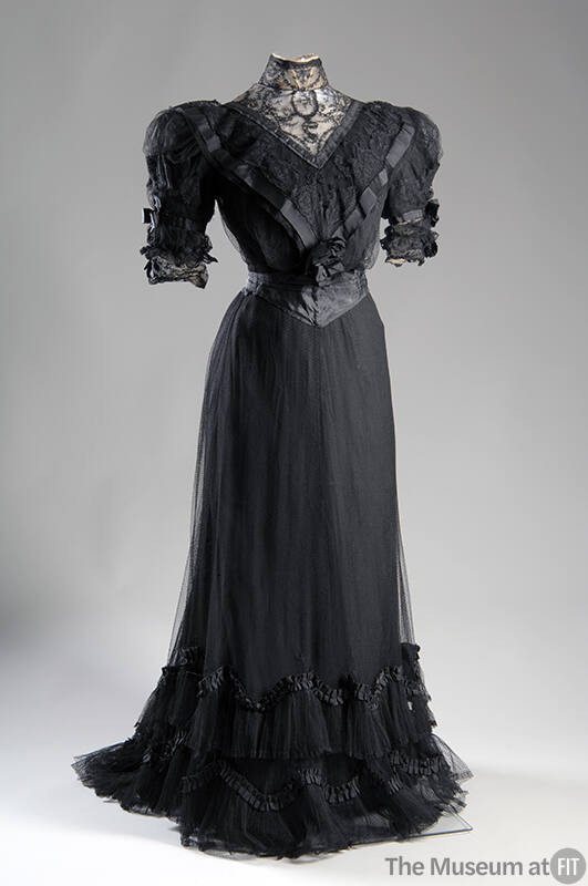 Short sleeve black dinner dress lace bodice with puff sleeves and matching skirt with small tra…