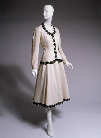 White suit with black lace border on jacket and hem, ankle length fit and flare skirt