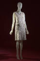 Silver sleeveless above-the-knee evening dress with horizontal bands of white lace and beading,…