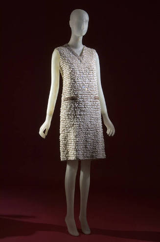 Silver sleeveless above-the-knee evening dress with horizontal bands of white lace and beading,…