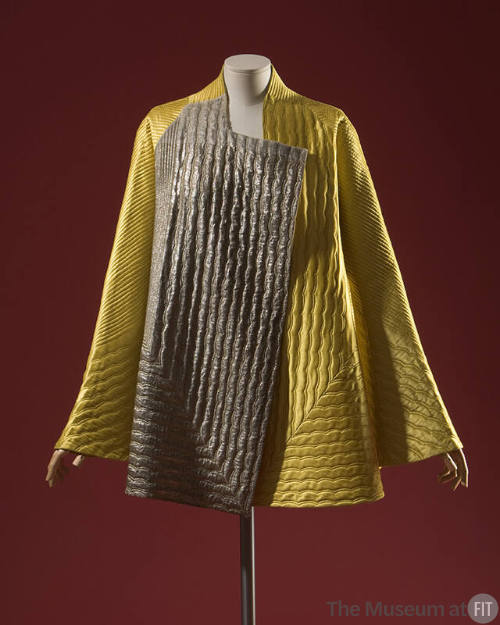 Yellow and silver hip length flared coat with parallel rows of quilted stitching
