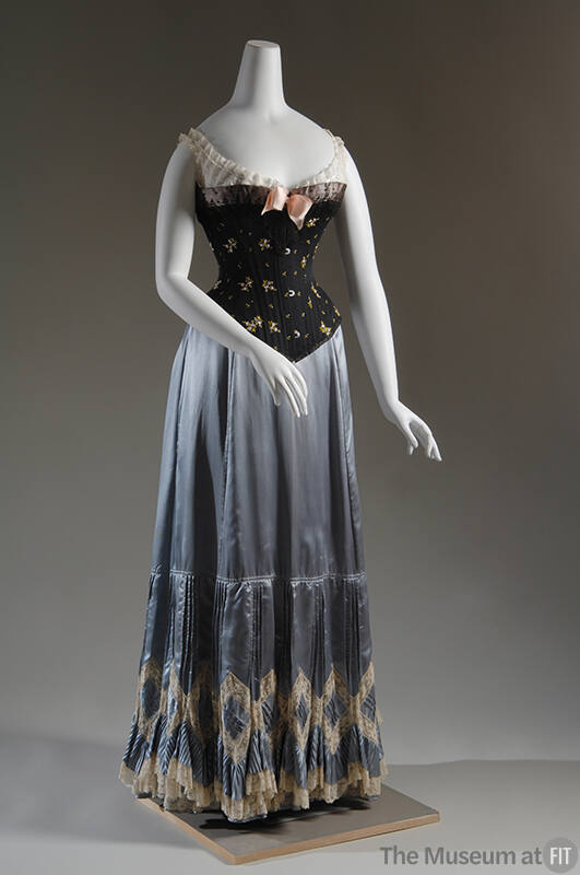 Black floral embroidered corset with white lace corset cover and light blue petticoat with whit…