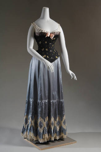 Black floral embroidered corset with white lace corset cover and light blue petticoat with whit…