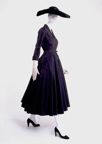 Black calf length dress with ¾ sleeves, fitted waist and flared skirt dressed with matching wid…