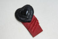 Black pin of thee concentric hearts with red grosgrain ribbon trim in four lengths 