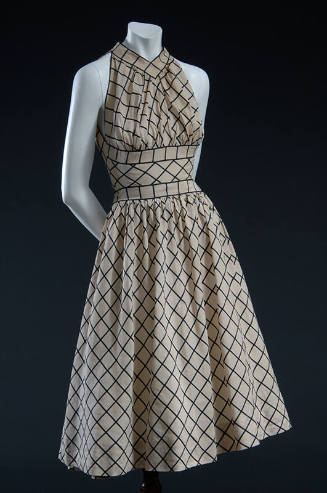 Beige and black windowpane check dress with halter neck, midriff panel and calf length flared s…