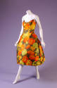 Strapless calf length cocktail dress in floral pattern of yellow, orange and green