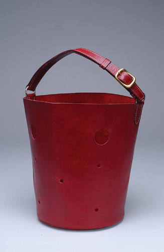 Red leather bucket shaped handbag with cut-out circles