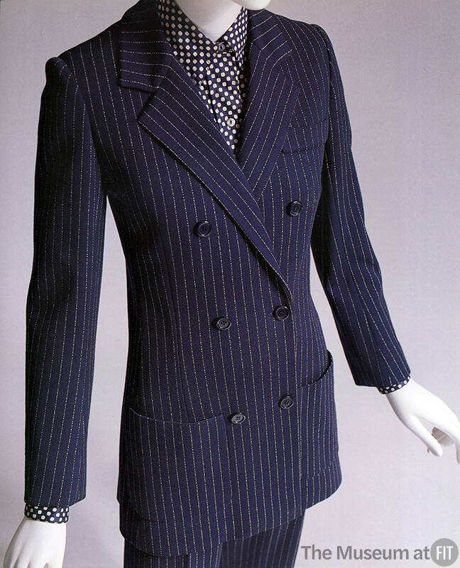 Navy blue double-breasted pantsuit with white pinstripe and black dotted shirt
