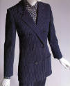 Navy blue double-breasted pantsuit with white pinstripe and black dotted shirt
