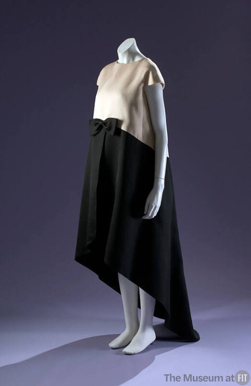 Evening tent dress with white capsleeve bodice and black flared skirt with asymmetrical hem 