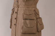 Close up of brown and cream check dress with four flap pouch pockets on right and left sides
