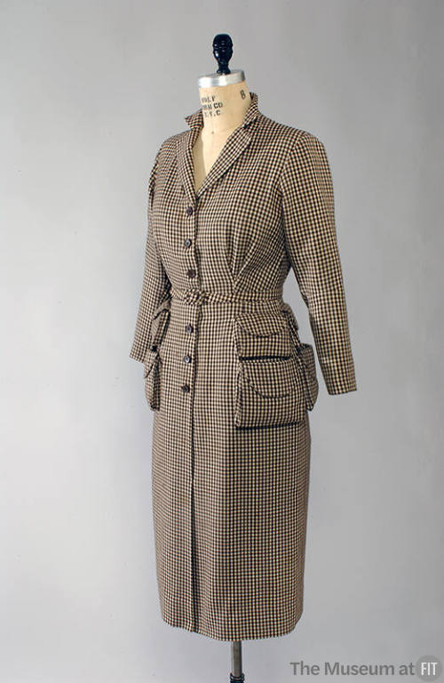 Brown and cream check button front dress with four pockets, padded shoulders, and buckle belt