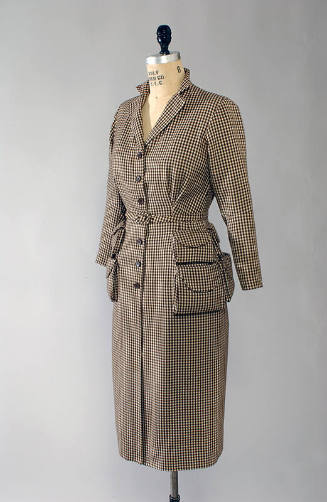 Brown and cream check button front dress with four pockets, padded shoulders, and buckle belt