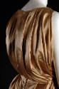 Back of champagne beige sleeveless bodice, draped with loose vertical folds