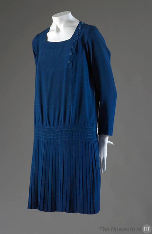 Peacock blue long sleeve dress with drop waist and knee length pleated skirt