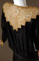 Black dress with mustard yellow lace detail on upper back