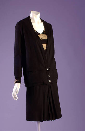 Black suit with cardigan jacket, tunic sweater with black and tan stripes, black skirt