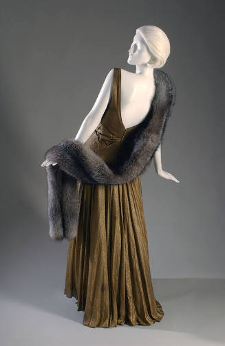 Gold lame evening dress with low v back and fur stole