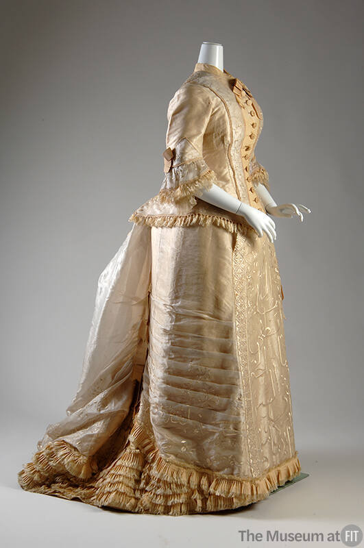 Embroidered cream two piece dress, high neck boned bodice, skirt with train