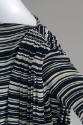 Detail view of right shoulder of white striped tent dress showing shirring of fabric