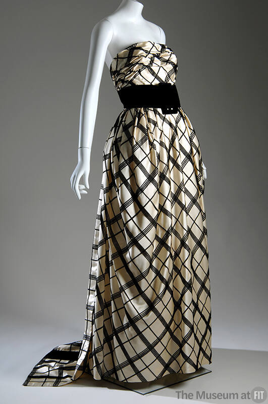 Black and off-white plaid strapless evening gown, floor length, with wide black buckled cummerb…