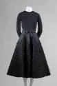 Black evening dress with long sleeved jersey bodice and below the knee skirt with jet beaded bl…