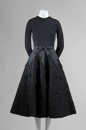 Black evening dress with long sleeved jersey bodice and below the knee skirt with jet beaded bl…